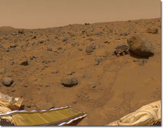 Sojourner on the surface of Mars. Tracks in the terrain indicated its progress from the lander ramp at the lower left to the large rock (Yogi) at the upper right.