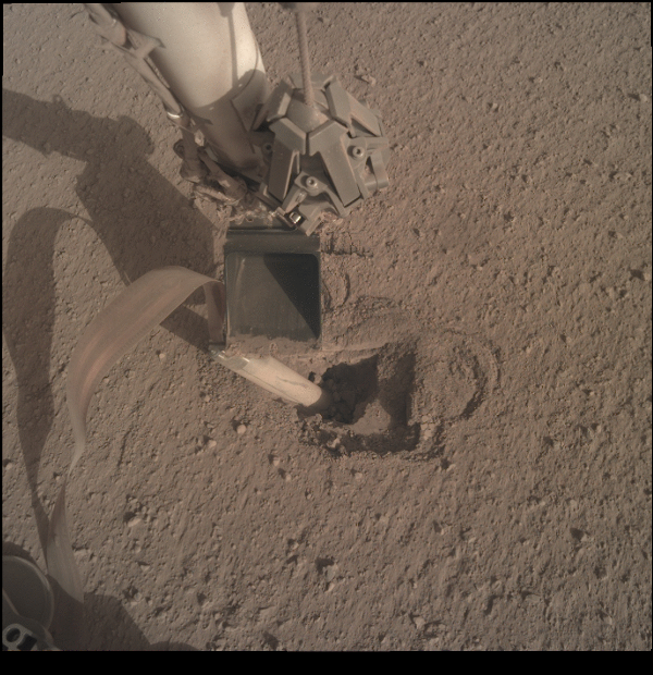 Figure 2: A view from the IDC of the IDA pressing against the back of the HP3 mole as it hammers into the Martian surface.
