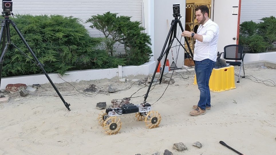 Matthew Suntup running performance tests on Mini DuAxel in the Mini Mars yard with a motion tracking system.